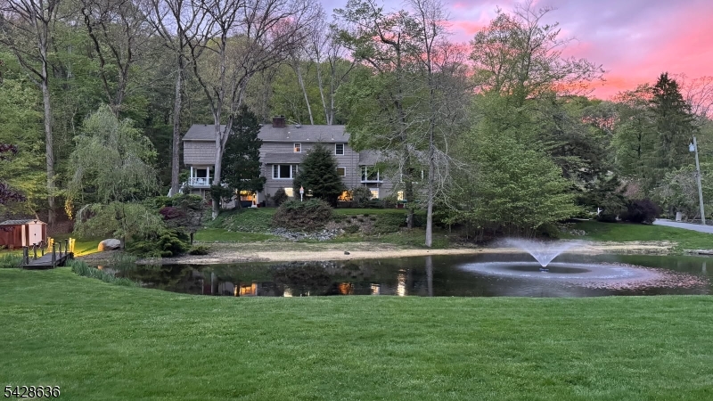 Peace and Tranquility Await in the park-like oasis to call home! Natural dam waterfall, pond w/fountain surrounded by lush mature specimen trees and shrubs. Your very own piece of natural serenity; situated behind the private gates of the Smoke Rise active community.  Country living yet near NYC, premiere shopping/restaurants.  Enjoy top rated schools Kinnelon has to offer as well as close proximity to skiing and the Jersey Shore!  The best of both worlds! Three levels of elegant living space to include many rooms offering picturesque views of the pond and gorgeous natural setting this lot affords.  This home offers both spacious living space for the largest of gatherings and cozy intimate settings for those special occasions. Timeless elegance exudes with the gorgeous hardwood flooring, built-in cabinetry and special touches throughout all 3 levels.Trex porch remodel, New Roof and water pump 2021, 2025 hot water heater, whole home generator...
