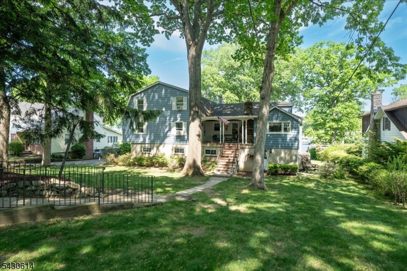 For the first time in decades, one of Indian Lake's most iconic lakefront properties is ready for its next chapter.  Set on a premier double lakefront lot w/sub-dividable potential, this rare offering combines timeless character, exceptional scale & extraordinary opportunity.  Spanning approx. 4,500 sq ft, the sprawling property features 7 bedrms & 4 baths, including a separate 3-bedrm apartment with full kitchen-offering incredible flexibility for an in-law suite, guest quarters or potential rental income.  Built w/solid I-beam construction, this home showcases craftsmanship & durability rarely found today.  The main level offers expansive entertaining space, scenic lake views, wood-burning fireplace, formal dining rm & large primary kitchen that has long served as the heart of the home.  The walk-out lower level opens directly to the backyard & lake area, featuring a large recreation space, full bath, office/bedroom, and secondary kitchen ideal for lakeside entertaining & hosting.  Located in the vibrant Indian Lake community, residents enjoy year-round events, boating, fishing & convenient access to Denville's award-winning downtown, major highways & NYC transit.  For buyers w/a vision for the future, the property's unique double lot presents the rare potential to create 2 luxury lakefront homes.  A home filled w/history, heart, timeless craftsmanship & endless possibility - this truly is a special opportunity to own one of Indian Lake's most iconic waterfront properties.