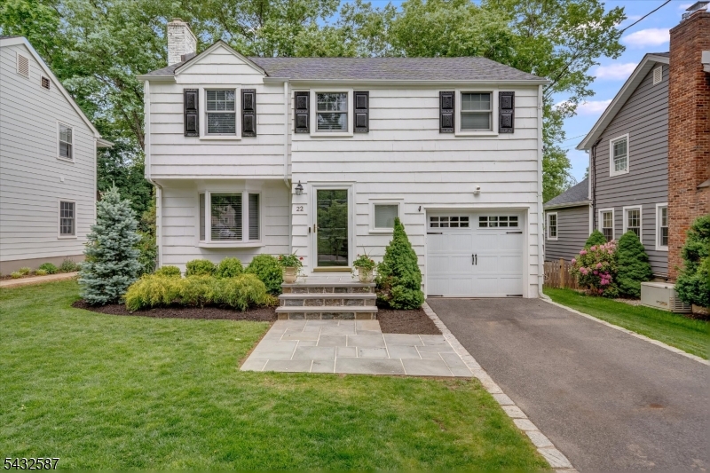 Nestled in the sought after Lafayette neighborhood this charming Colonial blends timeless character with modern amenities. A designer palette, hardwood floors and vintage details create warmth and elegance throughout. The entry features a guest closet and opens to a living room with a fireplace flanked by built-ins. The updated open-concept kitchen and family room offer the perfect space for everyday living and entertaining. A stylish full bath and easy access to the garage complete the first floor. Upstairs features a large primary bedroom with two closets and built-in storage, two additional bedrooms, and a dedicated office, with a completely renovated bath with radiant heat flooring. The brand-new lower level is finished and adds exceptional living space, including a family room, play area, pantry storage, and a thoughtfully designed laundry space with a sink, folding station, and additional cabinetry.  The same attention to detail found throughout the interior extends seamlessly to the outdoor living spaces. Enjoy a lushly landscaped backyard with a deck and a beautifully designed patio and cozy fire pit. This ideal location is close to top-rated Chatham schools, Midtown Direct trains, and downtown with its many specialty shops and dining options.