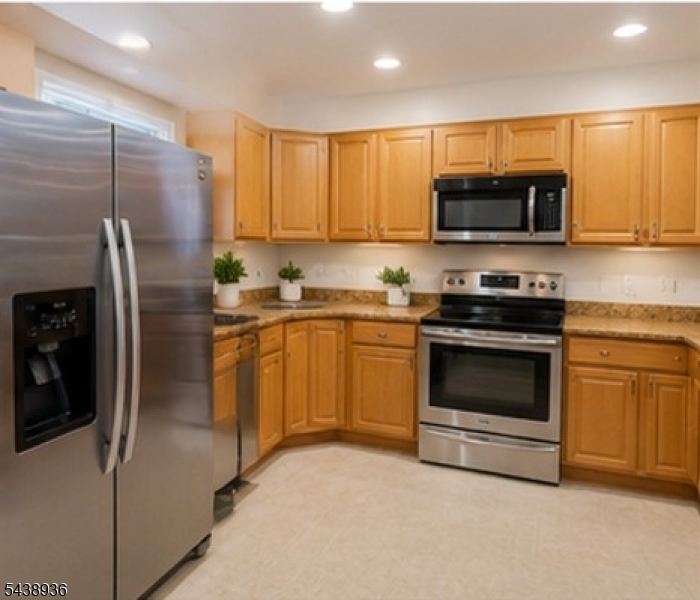 Welcome to 5 Edith Place located in desirable Somerset Glen   a well-maintained townhome community in the heart of Franklin Township with easy access to Rt. 27, the NJ Turnpike, Jersey Ave. train station, Rutgers University, and an abundance of shopping and dining options. This NORTHEAST-facing 3-bedroom, 2.5-bath colonial-style townhome offers a bright, open layout across multiple levels, complete with a 1-car attached garage and private driveway. As you enter through the northeast-facing front door, you are welcomed by a soaring double-height foyer that sets the tone for the rest of the home. The main level features a formal dining room with recessed lighting, an eat-in kitchen with granite countertops, stainless steel appliances, and rich brown cabinetry, plus a spacious living room centered around a gas fireplace with sliding door access to a private deck overlooking the backyard. Upstairs, the generous primary suite offers a walk-in closet and a full en-suite bath, joined by two additional well-sized bedrooms and a full hall bath. The unfinished basement with newer washer and dryer presents a great opportunity to add finished living space and includes ample room for storage. With quick access to major highways, public transit, top universities, and everyday conveniences, this is comfortable, low-maintenance living in one of Somerset County's most sought-after and accessible communities.
