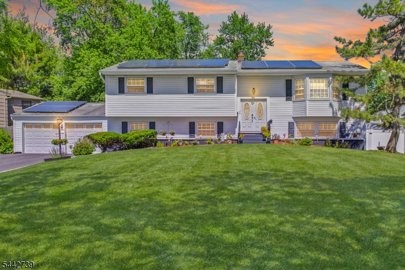 Welcome to this meticulously maintained 6-bedroom, 3-bath home in the highly desirable Lawrence Brook development. Originally the community's model home, this spacious two-story residence offers more living space than others in the neighborhood & is ideally situated on a quiet residential street. The beautifully updated kitchen features quartz countertops, a subway tile backsplash w/decorative mirror accents, SS appliances, a double wall oven, cooktop, expanded pantry space, additional cabinetry, pull-out spice rack, 2 lazy Susans, &  eat-in area.  Main level boasts a large formal living room, expansive formal dining room & gorgeous hardwood flooring throughout. All 3 bathrooms have been recently remodeled and feature stylish finishes, double-sink vanities, granite countertops, ceramic flooring & built-in linen storage.  Spacious primary suite offers its own private bath & generous closet space. Downstairs, the inviting family room is perfect for relaxing, complete with a gas FP & sliding glass doors leading to a fully fenced backyard with paver patio and storage shed. Additional highlights include solar panels, newer mechanical systems, a two-car garage, and a prime location with easy access to the NYC bus hub/transportation, shopping, restaurants, and Exit 9 off the New Jersey Turnpike. Back roof is 5 years old, Front roof will be replaced and solar panels put back prior to closing. This exceptional home combines space, updates, and locationan opportunity not to be missed!
