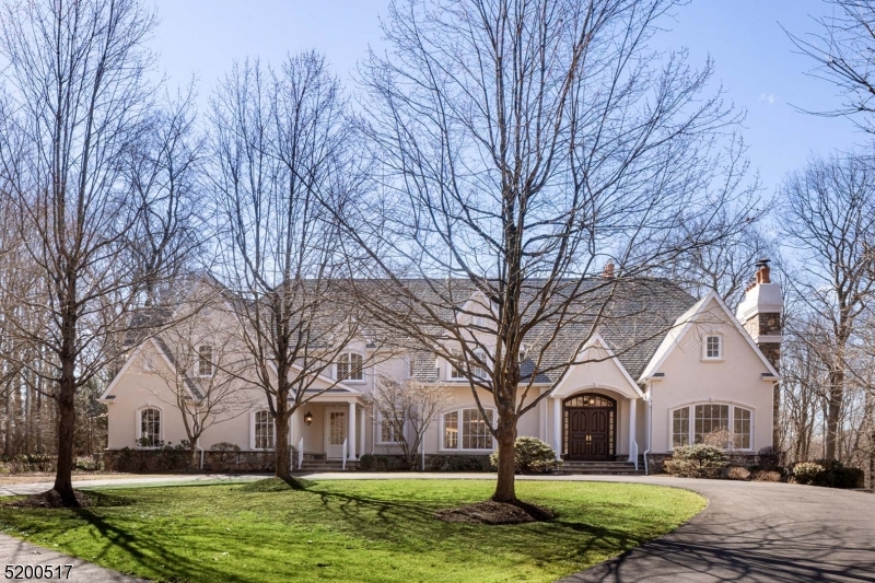 Privately set in a sought after neighborhood, this beautiful custom home checks virtually every box for comfortable living. Set at the end of a cul-de-sac, approx. 8 lush acres of open lawns, woodland, & specimen plantings provide the home's stage. Indoors bountiful light arrives from walls of windows, select window banks measure up to 11' wide. Gracious features of the almost 8000 SF residence include architecturally detailed well-proportioned spaces, hardwood floors, frequent arched passages, 5 fpls, 3 levels of high ceilings. Six Bedrooms including a first floor BR and full Bath. Double height Great Rm w/ ceiling height limestone fpl, wet bar, full wall view to rear grounds w/balustrade framed bluestone terrace, paver terrace w/ barbecue and hot tub. Living Rm w/ fpl, Dining Rm w/ coffered ceiling, each w/ wide arched entries from the 2-story Foyer. Paneled Library w/ built-ins. Sunroom. Kitchen w/ light-hued cabinetry, granite-topped 11+ ft island and quality appliances. Large window filled informal dining area. Also, main floor Office; Butler's Pantry; Mud, Laundry, & Storage Rms. Upstairs Primary Suite enjoys its own wing; luxurious BR, Bath, large walk-in closet. Plus, 2 en suites, 2 BRs sharing bath, Bonus Rm & large Storage Rm. Walk-up stairwell to attic.Unfinished, walk-out, daylight lower level allowing for high ceilings. Present are stone fireplace, multiple windows, French doors opening to patio, plumbing for bath & staircase to 3.5-bay Garage with epoxied floor.