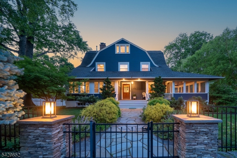 Tucked away amid lush greenery & vibrant perennial gardens in the coveted Erwin Park section, this enchanting & completely updated Colonial offers a rare sense of privacy & timeless elegance. A welcoming open front Porch sets the tone for the elegance & comfort found throughout. The gracious Foyer opens to beautifully designed living spaces including a stunning Living Rm centered around an oversized WBFP, an inviting Den & an elegant Dining Rm w/ a built-in buffet flowing seamlessly into the chef's Kitchen. French doors lead to the spacious 3 season screened porch, while the expansive rear deck with built-in grilling area is ideal for indoor-outdoor entertaining. Thoughtfully designed, the stylish Kitchen features granite counters, custom cabinetry, center island seating, a built-in beer tap, and picturesque views of the .41 acre parklike, fully fenced yard. Powder Room completes this level. Upstairs, the serene Primary Suite offers generous closets & Bath w/ an oversized shower, soaking tub & radiant floor heat. Two additional Bedrooms & hall Bath complete this level. The third floor provides an ideal private retreat featuring a fourth Bedroom with skylights & a full Bath. The finished Lower Level adds exceptional versatility with a Recreation Room, full Bath, and abundant storage space. A detached two-car Garage & EV charger complete this truly special home. Ideally located just one-half mile from Watchung Plaza Station for NYC direct train service, dining & shopping!