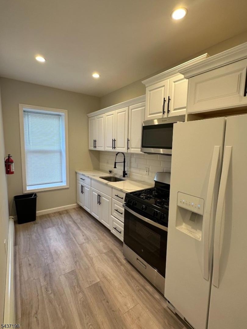 Welcome to this beautifully renovated 2 bedroom 1 bathroom first floor apartment located in the heart of Elizabeth's Historic District. This apartment features 2 great sized bedrooms, a kitchen with quartz countertop, stainless steel appliances, living room with a decorative fireplace, washer/dryer, and much more. Shared backyard access included! Conveniently located from shopping centers, grocery stores, restaurants, schools and transportation to the city and Newark airport. WILL NOT LAST!