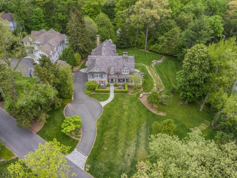 Superb craftsmanship and masterful design is uniquely embodied in this luxurious custom home on 1.36 acres of stunning, private property adjacent to the South Mountain Reservation, allowing for expansive nature views.Designed by renowned architect Al Bol AlA, decorated by acclaimed interior designer Debra Blair, and constructed by Russell Schiafo, this home is a masterpiece with no expense spared in finishes or in detail.This home features generously sized 6 bedrooms, each with its own en-suite bathroom featuring Waterworks fixtures and Ann Sacks tile, a new gourmet Bob Bakes kitchen with white inset cabinetry and Carrara countertops.Designed to feel like a luxurious high end hotel, the expansive primary wing has an intimate sitting room, dual walk-in closets and a spa-like bath with radiant flooring.Additional custom touches include impressive millwork throughout, multiple home office spaces, two main level powder rooms, a walk-out lower level with a private bedroom suite, recreation room, lounge, and future home theater.A 3 car garage with lift that can accommodate a fourth car.This decorators' showpiece includes sophisticated lighting fixtures and custom paint finishes, emphasizing its curated high style.Marvin high-efficiency windows, ultra-high efficiency Carrier 9-zone HVAC, Crestron audio/video, LED lighting and Lutron exterior lighting systems all offer state-of-the-art performance rarely seen in a private home.This exceptionally refined home is not to be missed.