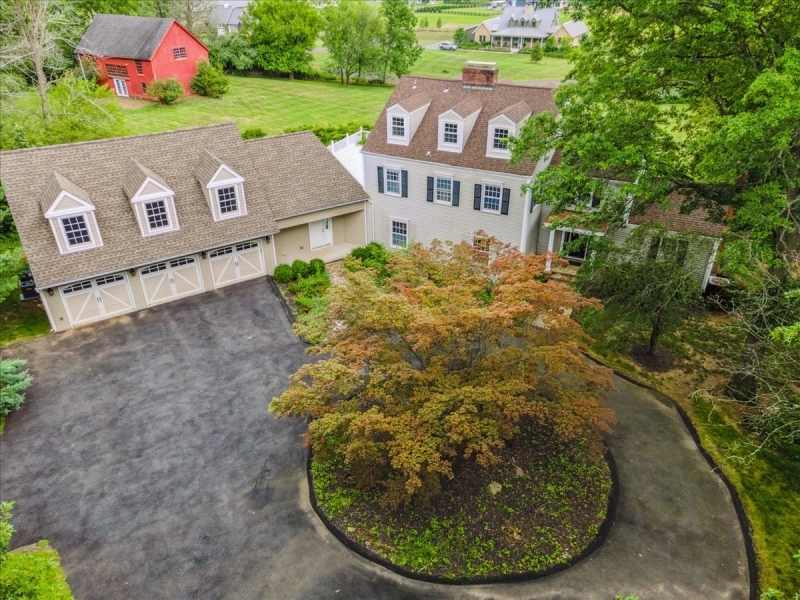 Elegant Custom Colonial, nestled on almost 4 acres offering 4 Bed, 4 Baths, 21/2 Baths, an office, oversized 3-car garage & a charming 2-story red barn. Near highly regarded schools, shops, eateries & minutes to the Far Hills NJ Transit train station to NYC. The spacious interior features floor to ceiling  windows offering panoramic views of the grounds, gleaming hardwood floors, crown molding, raised panel wainscoting & custom built-ins. A circular driveway & stone walkway guide you inside to a large foyer. Spacious living room has a wood burning fireplace. French doors open to rec-room perfect for entertaining w/wet bar, 1/2 bath & spectacular views from 4 sets of French doors opening to both patios. The formal dining room flows to the renovated, modern eat-in kitchen w/honed granite counters, coffee bar, double Thermidor ovens, 2 dishwashers, oversized center island, breakfast area & windows offering sweeping views of the property & beyond. The office includes a fireplace & walls of shelving + cabinets under a vaulted, wood-beamed ceiling. A separate side entrance to a bonus room that can be used as game room, gym, au pair suite. Mudroom with dog shower, laundry & access to the attached garage. The 2nd floor includes the primary bedroom suite w/huge WIC, lavish en suite bathroom, fireplace & French doors to a large, private terrace. There are 2 adit'l Bds, one w/en-suite bath, plus a full hall bathroom. The 3rd floor offers a spacious 4th Bd w/private full bath.