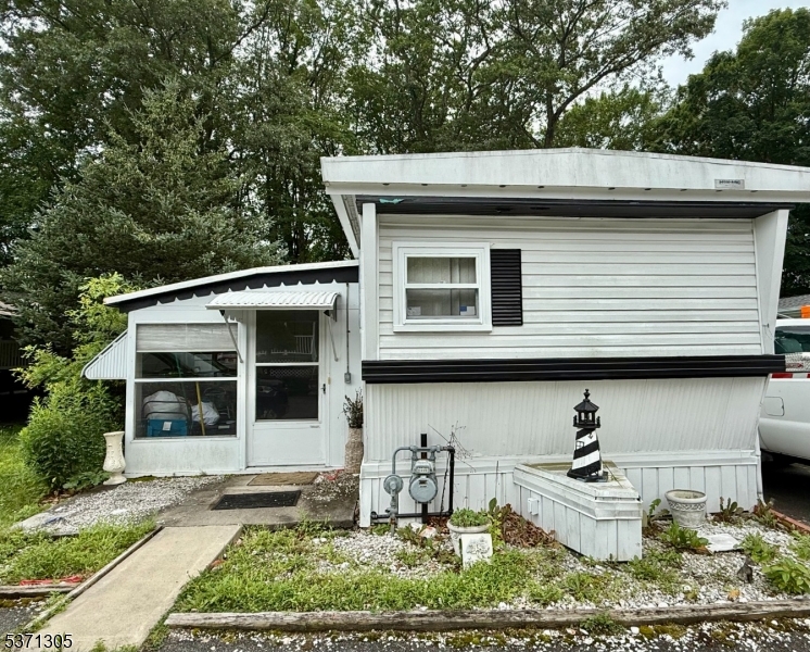 Hoffman Mobile Home for sale in a beautiful, quiet community near Rockaway Mall and easy access to Rt 80! This 2-bedroom, 1 full bath Ranch home features an eat-in kitchen, a spacious living, 2 bedrooms, bath with stackable laundry and am oversized sunroom. Tons of potential!! Storage shed & carport with driveway.