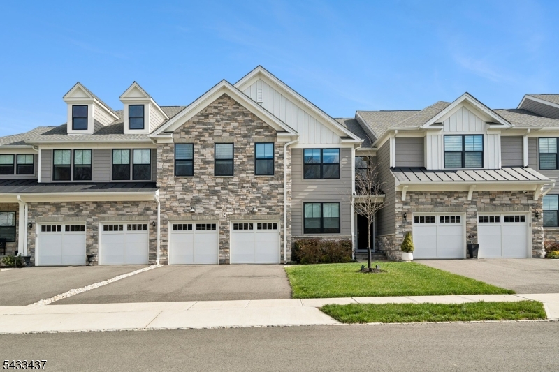 *First Floor Primary Suite*. The Amberley model offers exceptional style, comfort, & versatility. A dramatic two-story foyer welcomes you into an open-concept design that effortlessly connects the gourmet kitchen, great room, & casual dining area creating the perfect setting for both everyday living & entertaining. Designed with the home chef in mind, the kitchen showcases upgraded stone countertops w/ rounded edges, designer lighting, stainless steel appliances, & a gas cooktop. The adjoining great room features an upgraded fireplace & enhanced lighting, adding warmth & elegance to the heart of the home. The first-floor primary suite provides a peaceful retreat with two spacious walk-in closets & a spa-inspired bath complete w/ dual vanities & a seated shower. A flexible main-level bonus room offers ideal space for a home office, study, or additional guest area. Upstairs, you'll find two generously sized bedrooms, full bath, a versatile flex room, & a spacious loft overlooking the foyer below. The fully finished walk-out basement significantly expands the home's living space. It features a large family room, den, flex room & full bath with direct access to the rear common area perfect for guests, recreation, or expanded living. Step outside to a spacious deck overlooking unobstructed views and tranquil OPEN Space, offering both privacy and serenity. Enhanced lighting fixtures, refined finishes, & dual tesla chargers complete this beautifully designed and move-in-ready home.