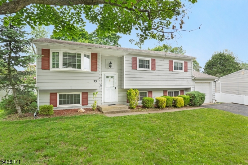 Discover this move-in ready 4-bedroom home in the desirable Sunrise Park section of Succasunna, NJ, conveniently located near Horseshoe Lake, top-rated Roxbury schools, shopping, dining, and major commuter routes including Routes 10, 46, and Interstate 80. Offering a spacious and versatile layout, the main level features an open-concept living and dining area with vaulted ceilings, gleaming hardwood floors, and abundant natural light perfect for both everyday living and entertaining. The bright eat-in kitchen boasts stainless steel appliances, abundant oak cabinetry, a stylish tile backsplash, and sliding glass doors leading to the deck, creating seamless indoor-outdoor living and the perfect space for summer gatherings. Upstairs, the spacious primary bedroom comfortably accommodates a king-size bed and offers double closets for ample storage. Two bedrooms and the full bathroom finish this main floor. The lower level expands the living space with a large family room ideal for movie nights, recreation, a home gym, playroom, or home office. A fourth bedroom, half bath, laundry area, utility room, and excellent storage provide flexibility to meet a variety of needs. Direct access to the attached garage adds everyday convenience to this functional and well-designed home.