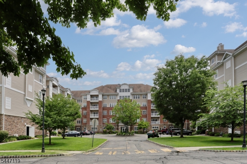 More than a home...it's a lifestyle. 1768 SF Colfax unit with a private hall entrance in the Del Webb 55+ active adult community of Wanaque Reserve set on more than 440 acres of beautifully landscaped and wooded grounds. Go out the side door of the building and you have the 20,000 SF clubhouse with indoor and outdoor pools, exercise room, cafe, sauna, billiards, exercise room and more than 45 clubs & activities. Some of the clubs are the travel club, casino trips, canasta, mahjong, poker, bocce, shuffleboard, ballet, art classes and many more. Tennis and pickleball courts are across the street. This home features beautiful hardwood floors, living room with sliding doors to the balcony, dining room, den/home office with French doors adding a touch of elegance, eat-in-kitchen with stainless steel appliances, granite countertop, tile backsplash, plenty of cabinets and pantry, laundry room of the kitchen with window, primary bedroom ensuite with tray ceiling, walk-in-closet updated with California closet, another closet, full bath, walk-in shower, double vanity and private toilet room, and 2nd bedroom and full bath. Wanaque Reserve offers a luxurious lifestyle for its residents with a focus on modern amenities, security and a sense of community. The recent renovation adds a fresh and updated living environment..