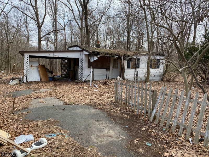 Level wooded lot, private end of of street, buyer responsible to remove existing bungalow, great opportunity to build in desirable neighborhood. There is an existing right-of-way through front lot for access (see survey).