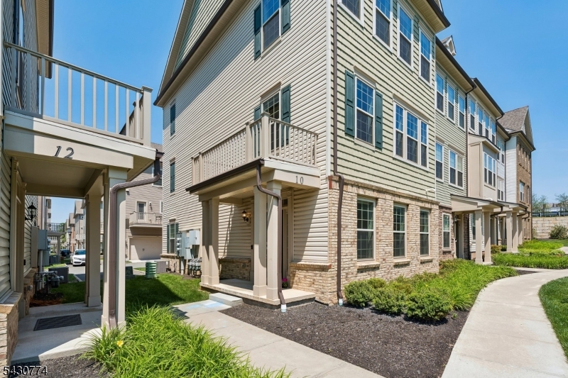 If you're looking in Livingston Square, this is the one you've been waiting for. A standout end-unit townhome perfectly situated on one of the community's most desirable courtyards, offering picturesque views of the manicured green space and charming gazebo right outside your door.Built in 2021 and meticulously maintained, this move-in ready home features 4 bedrooms, 3.5 baths, and three levels of thoughtfully designed living space. The entry level includes a private bedroom and full bath, ideal for guests, a home office, or flexible living arrangements, plus a two-car garage with electric vehicle charging setup just bring your own charger.The sun-filled main level showcases builder upgrades throughout, including upgraded cabinetry, appliances, hardwood flooring, and a large center island. The open-concept kitchen, living, and dining areas flow seamlessly to a private deck, creating the perfect setting for everyday living and entertaining.Upstairs, the spacious primary suite offers two walk-in closets and an en-suite bath. Two additional bedrooms, a full bath, and convenient laundry complete the level.Additional upgrades include a whole-house carbon filtration system and water softener for enhanced water quality and everyday comfort.Enjoy the benefits of newer construction, low-maintenance living, and an unbeatable location close to shopping, dining, recreation, and everything Livingston has to offer.