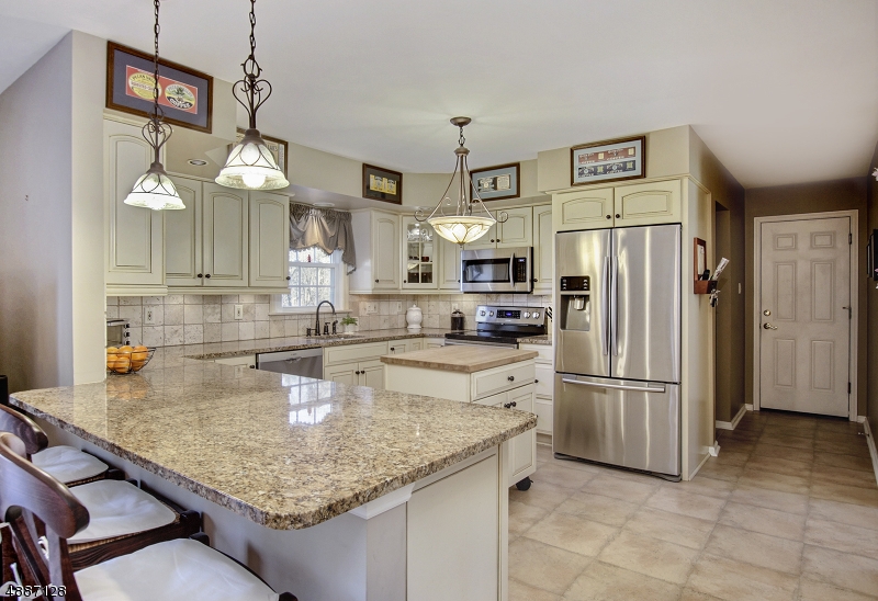 This beautiful fully updated 4 bed, 2.5 bath colonial has much to of The gourmet kitchen with granite counters, gorgeous cabinets, breakfast bar and center island, open to the family room with hardwood floors,  fireplace and sliders to deck with majestic views of the park-like property, surrounded by 25 acres of preserved property. The light and bright living and dining room make this home ideal for entertaining. The master bedroom boasts a walk-in closet and spa-like master bath. These are just some of the finer points of this centrally located home close to major roadway, restaurants, recreation points etc.