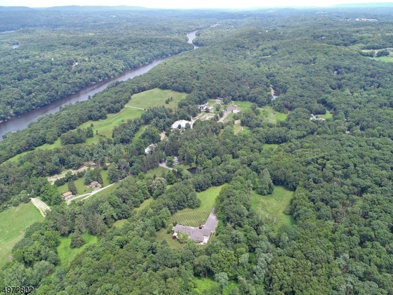 Meticulously designed 6000+ sf custom home sits privately on 20+ bucolic acres. Manicured landscaping & pristine woods bring tranquil ambiance to every room thru a myriad of oversized windows. The 6 bd/4.5 bath home boasts a great room w/ billiard area open to breakfast rm + chefs kitchen w/ hi-end appl, multiple sinks, DW, & ovens, Subzero fridge & freezer each 36 in. Large mudroom off oversized 3-car heated garage, 1st-floor office/bd w/ handicapped bath opens to private patio w/ FP.  The grand master wing has oversized LR, gas FP, & spacious master bedroom that opens to patio. The spa-like master bath boasts radiant heat, steam shower & 2 sink areas lead to a customized WIC. Includes auto-switch whole house generator. This masterpiece highlights elegance, functionality & the quality you desire.