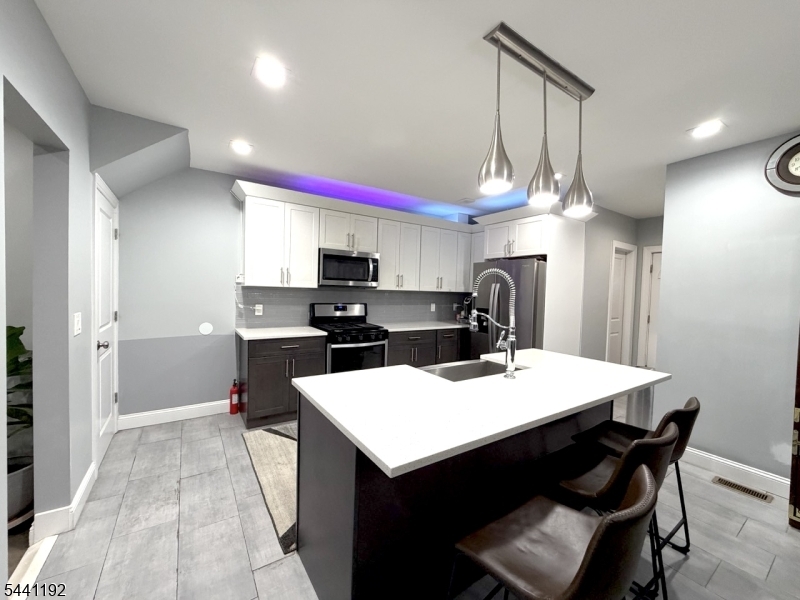 Welcome to this beautifully newly renovated and maintained 4-bedroom, 2-bath and 2-helfs bath. Home located in one of Union's desirable residential neighborhoods. This spacious residence features a newer kitchen with modern finishes, a large center island with white quartz, gray Glassy backsplash and farm think, perfect for entertaining, and updated bathrooms throughout. The home offers a combination of hardwood, laminate, and tile flooring, creating both warmth perfect for entertaining, and updated bathrooms throughout. The home offers a combination of hardwood, laminate, and tile flooring, creating both warmth and durability. 1 car garage equipped with a Tesla charger for added convenience and long driveway fit 4 cars. Enjoy comfortable indoor and outdoor living Conveniently located just minutes from Route 22, the Garden State Parkway, Interstate 78, and the New Jersey Turnpike, offering easy access for commuters. The property is also approximately 1.5 miles from the Union NJ Transit Train Station, providing direct service to Newark Penn Station and New York City. Close to shopping, restaurants, parks, schools, and all the amenities Union has to offer.Don't miss this opportunity to own a move-in-ready home that combines modern updates, convenience, and an excellent location.