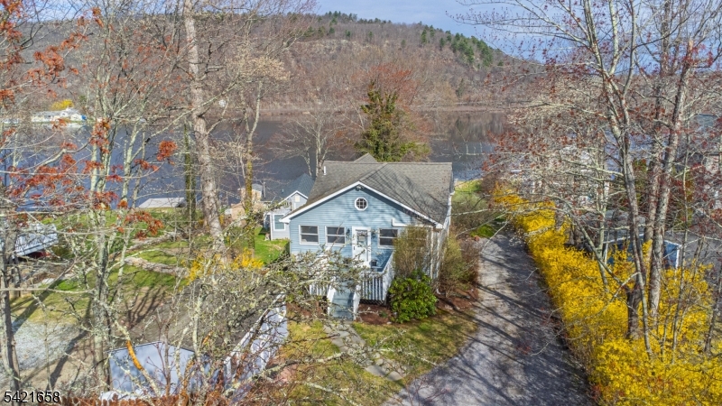 Gorgeous Lakefront home on the West Shore of Culver Lake set on a large, level, private lot with ample parking and a boathouse. This property offers year-round living with direct water access, a sandy beach area for wading, and western exposure providing incredible sunset views. The home features an updated kitchen with granite countertops, custom wood cabinetry, and stainless steel appliances. The dining area overlooks the lake and opens to an additional living space with a new pellet stove. A large utility room and full bath complete the lower level. The main level includes a living room with vaulted ceilings, two bedrooms with lake views, and an updated full bath. The upper level offers a loft suitable for office or flexible use, along with a third bedroom. Exterior highlights include a boathouse with electric and a water pump for irrigation, a large cantilever dock, and two large storage sheds. Additional features include a whole-house generator and furnace replaced in 2019. Located in the private 555-acre Culver Lake community, enjoy year-round access to boating, fishing, water skiing, kayaking, a clubhouse, beach, and canteen. Conveniently located approximately one hour from NYC.  BRAND NEW 3 BEDROOM SEPTIC BEING INSTALLED BEFORE CLOSING! ENGINEERING COMPLETED.