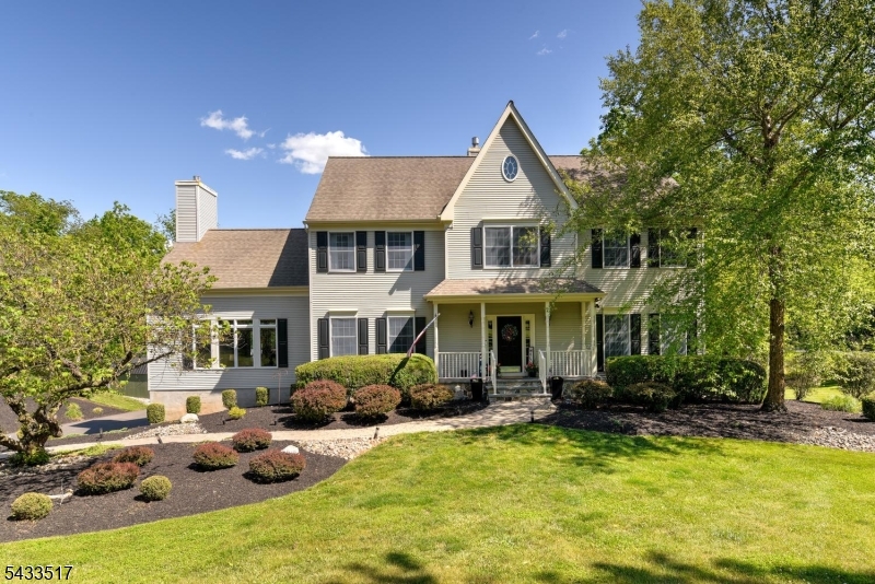 This beautifully maintained Colonial set in one of Branchburg's most peaceful and picturesque settings. Surrounded by mature trees, natural scenery, and lush landscaping, this home offers the perfect balance of privacy, comfort, and timeless style.Inside, a bright and open floor plan features soaring ceilings, walls of windows, French doors, and inviting living spaces designed for everyday living and entertaining. The impressive great room showcases a gas fireplace framed by custom built-ins, creating a beautiful focal point.The formal living room opens through French doors to a private den, ideal for a home office or quiet retreat. The sun-filled kitchen offers custom cabinetry, stainless steel appliances, and easy flow to the surrounding living areas. The spacious primary suite features a coffered ceiling, dressing area, and private bath with jetted tub.The finished walk-out basement expands the living space with nearly 500 square feet of new vinyl flooring, a full bath, wet bar, refrigerator, and flexible space for entertaining, recreation, guests, or extended living. The home has also been freshly painted and carefully maintained throughout.Outdoor living is a true highlight with a stunning 670 square foot custom IPE deck, circular staircase, lower stone patio, and a backyard surrounded by nature.