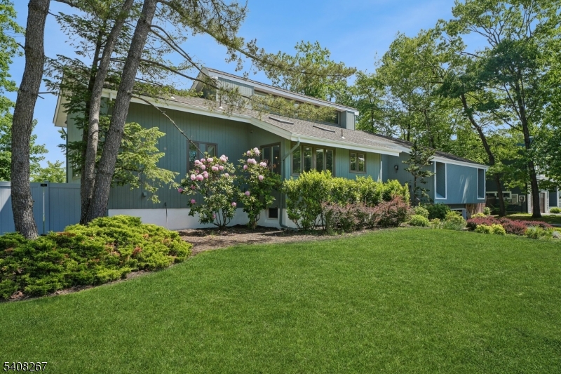 Nestled on a beautifully landscaped property in the highly sought-after upscale Newstead neighborhood of South Orange, this stunning contemporary residence offers the perfect blend of sophisticated design, comfort, and modern living. Surrounded by mature trees, the home's striking architectural lines, expansive windows, and serene setting create an exceptional curb appeal that captivates. Inside, an airy open floor plan is filled with natural light and thoughtfully designed for both everyday living and elegant entertaining. The dramatic living room and dining area feature soaring ceilings, oversized windows, and a central fireplace, creating a warm yet impressive gathering space. A modern eat-in kitchen with high-end appliances serves as the heart of the home, offering abundant cabinetry, generous prep space, and nearby access to the outdoor deck for indoor-outdoor living. The home offers a versatile and open floorplan with 3-4 spacious bedrooms and 2  well-appointed baths, providing flexibility for guests and home office needs. The finished basement expands the living space even further, with a recreation/media/play room, while a dedicated home gym adds convenience and wellness-focused living. Step outside to enjoy the large deck overlooking a lush lawn perfect for summer entertaining. Completing this exceptional offering is an oversized built-in garage with additional storage. A rare opportunity to own a turn-key home in one of South Orange's most desirable neighborhoods.