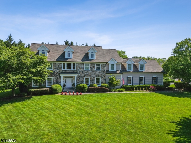 Stately, stone front, center hall colonial nestled quietly between 2 cul-de-sacs, in the desirable Coopergate Farm neighborhood of Basking Ridge!  Perfect flow for entertaining, with over 5,000 sf of living space across 3 finished levels.  Welcoming, 2-story entry foyer opens to spacious living room & dining room. A beautiful Billiards room includes a separate, temperature controlled, 500 bottle wine cellar.  Light & bright family room with stone fireplace, showcasing 2 sets of French doors to expansive deck with built-in natural gas grill, surrounded by mature privacy trees, full fence & sprinkler system. Stunning white kitchen with quartzite countertops, stainless appliances & matching butler's pantry. Large kitchen island with seating & separate dining area, including a back staircase to 2nd floor. Powder room, spacious laundry room & access to 3 car garage complete the 1st floor.  4 spacious bedrooms & 3 full baths on 2nd level.  Primary bedroom with tray ceiling, 2 walk-in closets, & ensuite with double sinks & newly tiled shower. 3 additional bedrooms including Princess suite, & jack-&-jill bath.  Beautifully finished basement with rec room, theatre room, gym area, storage room, workshop, full bath & 2nd private stairway directly to garage.  Fabulous neighborhood & highly sought-after town of Basking Ridge.  Access to highly rated schools, fantastic proximity to local shopping, dining, public transportation, settled between two major highways (287/78), & NYC!