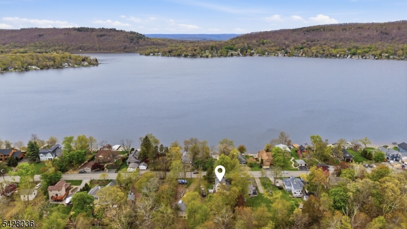 In the heart of CULVER LAKE, this beautifully updated lake home is more than a place it's a lifestyle rooted in community and connection. Wake up to stunning LAKE VIEWS and enjoy the ease of being just STEPS AWAY FROM THE WATER. Inside, the updated kitchen and spacious layout including 4 bedrooms plus a den offer room to grow, gather, and make lasting memories. A 2014 addition added three bedrooms and a full bath, creating flexible living for today's needs. Outside, a fenced yard and barn(equipped with electric) bring charm and functionality and a front porch to take in those beautiful views. With key updates already in place, this home is ready for its next chapter whether it's your everyday retreat or weekend escape.  New hot water heater in 2024, pellet stove that heats the whole house, foam insulation, shiplap to prevent drafts from the wind, captains window in upstairs bedroom and new septic in 2014 are just a few more perks!  Short distance to the club house for activities and beach! Access the lake directly across from your front yard for fishing, boating, swimming! Furniture can be included with the sale of the home minus a few select pieces the seller is taking with them.
