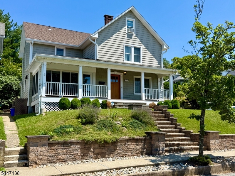 Thoughtfully renovated 3 bedroom, 2 full bath Colonial offering exceptional charm, modern updates and a versatile floor plan. At the heart of the home is a beautifully updated kitchen featuring rich blue cabinetry, quartz countertops, a farmhouse sink, stainless appliances and a six burner gas range. A spacious center island provides seating and houses a built-in wine refrigerator and microwave. A bright sunroom, convenient mudroom and full bath are all located just steps away. The dining room opens seamlessly to the living room, creating an inviting and connected space for everyday living and entertaining. The second floor features 3 bedrooms and a full bath. The primary suite includes an adjoining room ideal for a dressing area, home office, sitting room, or bonus space. The second bedroom is currently configured as an office, while the third bedroom provides staircase access to a fully sheet rocked walk-up attic offering valuable additional bonus space. The charming outdoor setting includes a paver patio perfect for dining, a second private patio, shed, fenced in vegetable garden and a detached garage with rear access. Additional highlights include a covered front porch with Trex decking and durable vinyl cedar shake siding. This tastefully designed layout blends comfort, functionality and character.