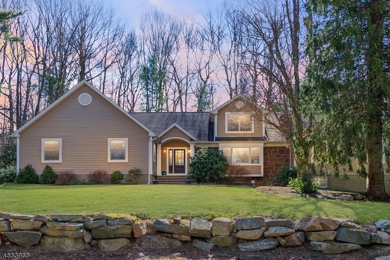 Much larger than it appears, this tastefully updated custom home in Smoke Rise offers lots of natural light, great flow, hardwood floors and plenty of privacy. You are welcomed from the foyer to the tasteful living room with window seating & woodburning fireplace. The kitchen has a center island, separate dining area, stainless steel appliances, granite countertops and easy access to the deck and backyard. There is a large family room with vaulted ceilings, a stunning dining room as well as powder and mud room. On the other side of the home is another full bathroom and four bedrooms (3 bedroom septic), including the master with a walk-in closet & en-suite bathroom with double sinks, jetted tub and stall shower. Upstairs is a loft space used as an office and attic storage. Great location and amazing amenities