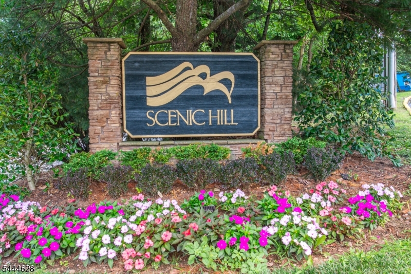 BRIGHT END UNIT in Desirable Scenic Hill on the border of Livingston & Short Hills, close to Saint Barnabas Hospital!  Freshly Painted SPACIOUS 2/3 Bedroom, 2 Bath Unit with OPEN CONCEPT: Kitchen w/ Breakfast Bar is OPEN to Dining and Living Room with Gas Fireplace. Slider to BALCONY overlooking LUSH setting and BEAUTIFUL VIEWS. A few Steps down to Family Room with Huge Walk-In closet creates a potential to be a 3rd Bedroom. Master En-Suite with HIGH CEILING, UPDATED Bath and Walk-In Closet. Nice-sized additional Bedroom w/Slider to Balcony & UPDATED Hall Bathroom. Enjoy an EASY lifestyle and Great Amenities this community has to offer including RENOVATED CLUBHOUSE w/ Exercise Room, Outdoor Pool, Tennis & Pickleball Court and Playground. Close to NYC transportation, restaurants, shopping and more.