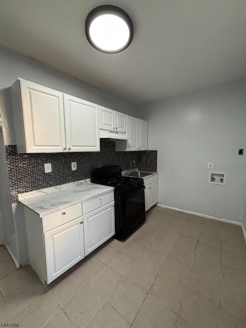 This renovated 2-bedroom, 1-bathroom apartment features spacious rooms, dark modern walls, recessed lighting, wood-style flooring, and attractive original details, including decorative fireplaces and large windows that provide plenty of natural light.The kitchen includes white cabinetry, stone-look countertops, a tiled backsplash, a refrigerator, oven, microwave, and washer-dryer hookups. Baseboard heating is provided.Conveniently located in Newark with access to local transportation, shopping, dining, schools, and major roadways. A great opportunity for tenants looking for a clean, updated, and well-located home