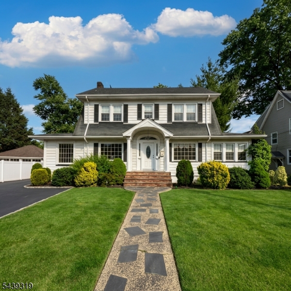 This beautiful home showcases timeless curb appeal with its striking white facade and classic Dutch Colonial gambrel roof. Inside, the expansive living room features pristine original oak hardwood floors with elegant mahogany inlays, centered around a charming brick fireplace that creates the perfect setting for cozy evenings. The updated kitchen offers crisp white cabinetry, high-end stainless steel appliances, and a stunning glass mosaic tile backsplash that adds both style and sophistication. A unique wood-paneled sunroom, ideal as a home office or reading retreat, is bathed in natural light through a wall of oversized windows .The finished lower level is a true highlight, featuring rich espresso-stained wide-plank flooring and a spacious open layout, perfect for a media room, fitness area, recreation space, or playroom. While the home could benefit from some TLC and cosmetic updates to reach its full potential, it offers incredible character, generous living space, and endless possibilities. Located in a peaceful residential neighborhood, this is a wonderful opportunity to create your dream home. Note that the correct lot size is (65x170) 11,050 sq ft. Don't miss out schedule your private showing today!
