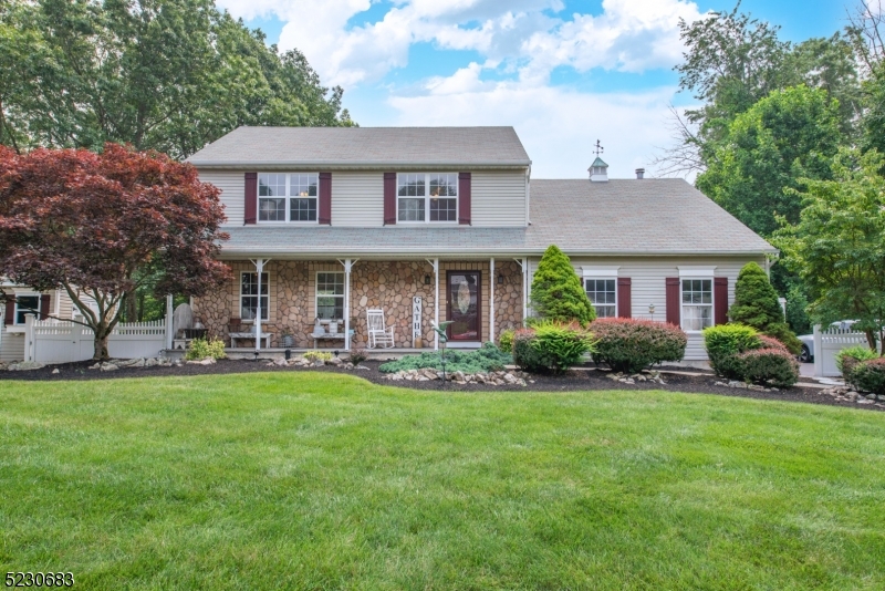So rare for a home in this fantastic subdivision to become available!  Spacious colonial with great curb appeal offers a covered rocking chair front porch, massive 2 tier deck with private views surrounds above ground pool with new filter, storage shed, recently paved driveway, generator hookup and more!  Formal living room features pellet stove, open to formal dining room, country eat-in kitchen with pantry, step-down family room is open to kitchen and offers recessed lighting and stone surround wood burning fireplace.  Upper level features primary suite with walk-in closet and ensuite bath, 2 additional bedrooms and main bath with tub/shower.  2nd floor bonus - laundry room and unfinished room could be made into 4th bedroom, home office, exercise room or suite with additional bath.  Unfinished basement has limitless possibilities.  Tremendous location - 5 minutes to Rt. 80, shopping, dining and NJ Transit Train.  Other features - public water/sewer, whole house fan, central air, newer water heater, storage shed.