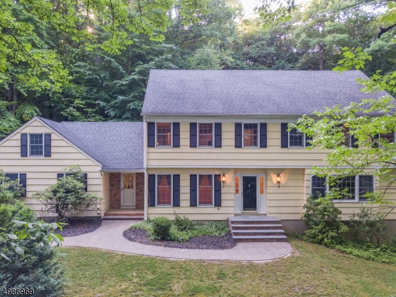 Warm, Comfortable Center Hall Colonial situated in wooded tranquility just mins to the Mendham border. The home features lots of buyer faves & updated features, such a new Andersen windows & baths. 1st floor open living w/center staircase, living, dining, family room & powder room. Plenty of versatile space. An eat-in-country kitchen provides easy access to laundry/mud room & garage entrance. 2nd floor offers master suite w/private bath. Plus 3 additional bdrms & office w/full bath off the hallway. HW floors, crown molding & recessed lighting throughout. Super-sized & dry bsmt w/tons of storage & possibility. 2-car garage & attic. Newer automatic doors. Nat gas heat & central air. Spacious & Gentile inside & out. Perfect for entertaining! Leveled, hardscaped backyard oasis w/ paver patio, firepit & bbq area