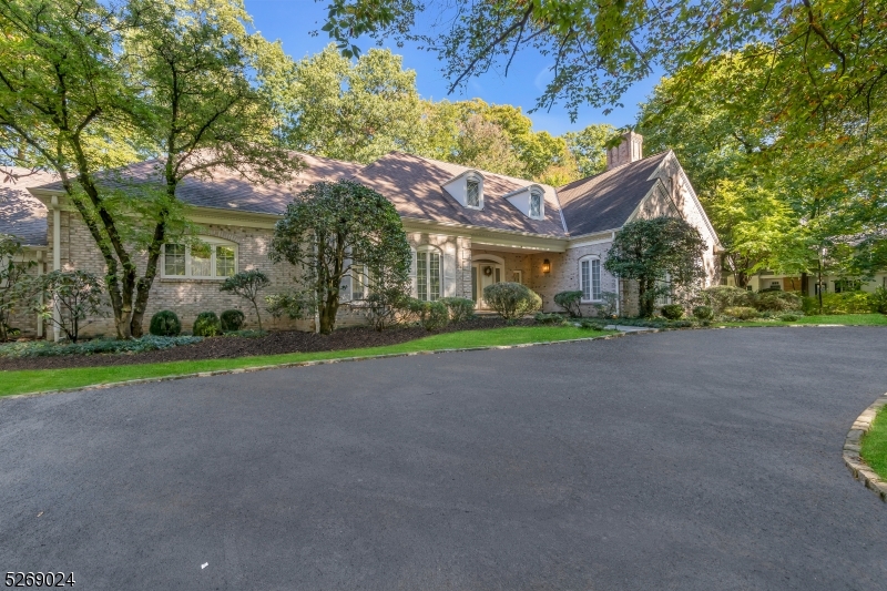 Welcome to the epitome of elegance on a sought-after street in the Hill section of Madison.  Sitting on almost 1.5 wooded and level acres, this Country French home boasts 4 bedrooms, 3 full baths, and 3 half baths.  The grandeur unfolds with two magnificent living rooms featuring soaring ceilings and wood-burning fireplaces, complemented by an inviting eat-in kitchen, expansive first-floor master suite, and a welcoming guest bedroom with ensuite. The second floor offers two additional bedrooms, accompanied by a full bath and ample space for expansion.  An oversized 2 car garage, mudroom, and sunroom add to the functionality of the home.  Delve into the possibilities of an expansive dual-entranced unfinished basement with half bath, stretching the entire length of the home.  A rare opportunity to renovate and create your dream home just a short walk from Madison's vibrant downtown and midtown direct train.  Home is being sold "AS IS . All room sizes are approximate.