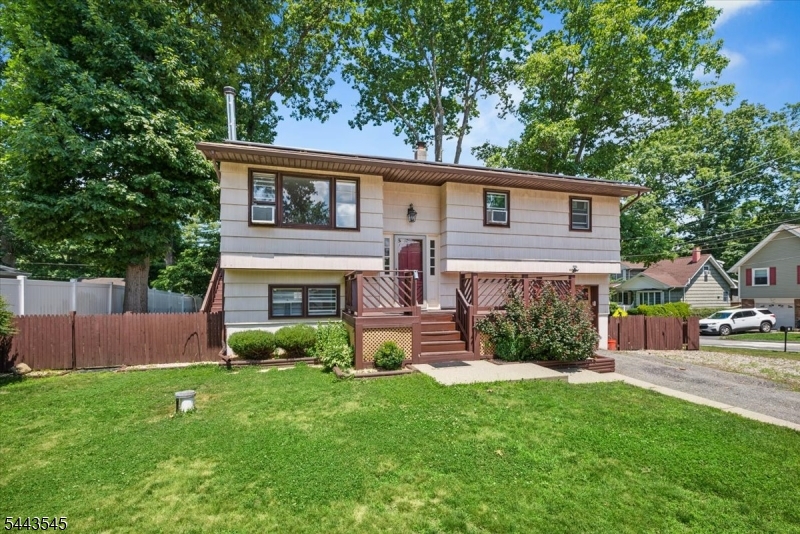 Welcome home to this beautifully maintained 3-bedroom bi-level situated on a large, level corner lot in Hopatcong. This inviting home features gleaming hardwood floors, recessed lighting, and an abundance of natural light throughout. The updated bathrooms offer modern finishes, while two full baths provide comfort and convenience for everyday living.The spacious third bedroom features a charming loft area with skylights, creating a unique and versatile space perfect for a play area or reading nook. The lower-level family room is warm and welcoming, highlighted by a cozy wood-burning stove perfect for relaxing on cooler evenings.Step outside to your fully fenced backyard, ideal for entertaining, pets, or play, complete with a multi-tiered deck overlooking the expansive yard. An oversized garage provides plenty of room for vehicles, storage, or a workshop. Solar panels offer added energy efficiency and the potential for lower utility costs.