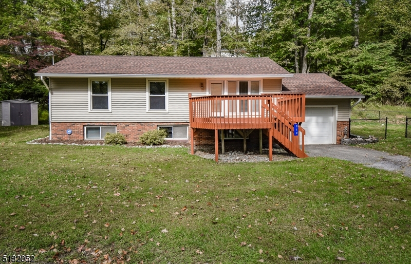 Move right in to this charming and spacious 3 bedroom raised ranch in desirable Paulinskill Lake.  This home shows pride of ownership inside and out.  Beautiful wood floors throughout and lots of windows for natural lighting.  Tons of cabinet space and room to work in the eat in kitchen.  Three generous sized bedrooms with large master with ensuite bath.  The finished basement is huge and features large laundry room and additional bonus room that could serve as a guest bedroom or office.  Attached garage for additional parking or storage.  Plenty of entertainment space outdoors as well with huge front and rear decks that have just been freshly painted, and a flat fenced yard round out this picture perfect home.  See it today!