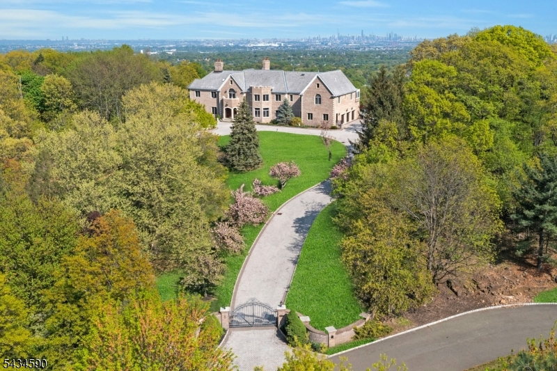 Set on a private Estate Road magnificent custom gate and a curving 450ft private road and long paver driveway lead to an elegant brick and limestone mansion set majestically on 5 plus acres with breathtaking NY City views ranging from the George Washington Bridge to the Verrazzano Bridge and the Bay. Only 15 minutes from Midtown Manhattan this truly unique estate, located both in Cedar Grove and Montclair blends timeless elegance with modern luxury an oversized resort style pool with spa create an idyllic setting for relaxation and High-level entertainment.