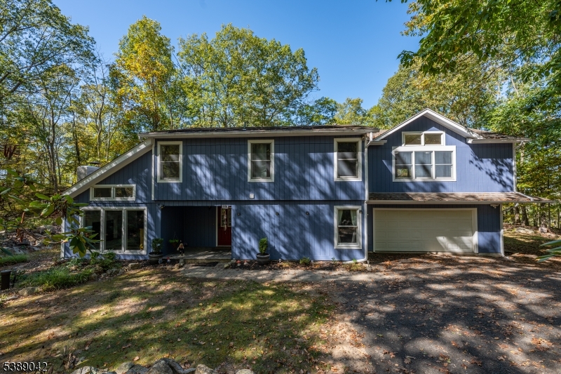 Beautiful custom home ideally located in a private oasis at the top of a cul-de-sac surrounded by nature. NEW natural gas furnace & hot water heater! NEW complete air conditioning systems, air handler and commercial attic fan. Upgrades include a new whole house water softener & water filtration system. The home interior and exterior are freshly painted and driveway repaved. Enormous family room has vaulted ceilings, wet bar and access to screened in porch attached to a wrap around deck. A true primary suite includes a private full bath and walk-in closet. Tons of storage space with an oversized two car attached garage and lots of closet space! This home is perfect for hosting with open style dining into the living room with a wood burning fireplace. The large kitchen has matching SS appliances including a Wolf range/oven with six gas burners and a new refrigerator and dishwasher. Options abound with a large first floor bedroom and large recreation room!