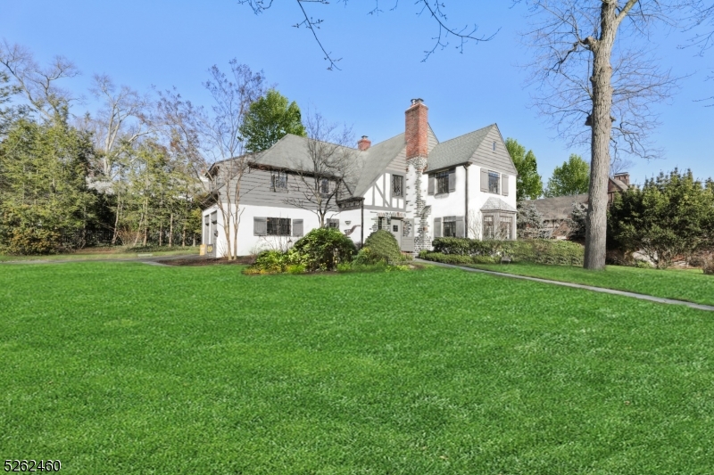 A fresh blend of elegance and timeless architectural treasures combined with today's modern amenities in the stellar Knollwood section of Short Hills ensures that 25 Hawthorne is the ideal home! This stunning 4 Bedroom, 3 Full and 2 Half Bathroom home is set back on a gorgeous lot on a quiet street within minutes to train, town and schools. This expansive turn-key Tudor has been updated top to bottom with a magical curb appeal plus an open and airy floor plan. The first floor features an out-of-this-world Gourmet Kitchen with top of the line stainless steel appliances, large island and built-in banquette that transitions to a dramatic Family Room with vaulted beamed ceilings, limestone fireplace and access to a private patio for al-fresco dining. The sunny Living Room boasts a second stone fireplace and bay window transitioning to the formal Dining Room plus a delightful sunroom / office. The Primary Suite provides 2 huge walk-in closets and a deluxe Full Bathroom. 2nd bedroom features windows on two sides and a spacious walk-in closet. 3rd bedroom provides direct access to the hallway full bathroom with shower over tub. Step down to the large Junior Suite with 3 closets and a private full bathroom with shower over tub. A convenient upstairs Laundry area completes the 2nd level. Lower Level has plenty of space for a Home Office or weekend sleepovers including a Recreation Room, a 31 foot long Game Room, and a Gym / Office / Guest Room with Powder Room.