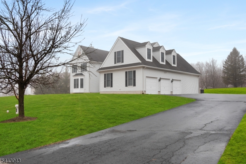 Exquisite 5 bedroom, 5 1/2 bath home in Kentview Estates, Raritan Township in sparkling move in condition.  East facing 5165 square foot home located on a lovely cul de sac featuring 13 luxury homes with  no traffic. Entry features a covered porch. 3 zone HVAC. 2 story reception foyer. Gleaming hardwoods throughout. Special feature - 1st floor bedroom with its own full bathroom. 1st floor offers kitchen with center island, granite counters, new refrigerator and dishwasher, along with a double oven. Convenient butler's pantry. Large eating area adjacent to kitchen with a built in desk. Sliding doors exit to small deck and backyard. Family room with vaulted ceiling, ceiling fan and gas fireplace. Large first floor office. Also 1st floor laundry room with a sink. 2 staircases to separate 2nd floor sections. Ensuite Master bedroom provides large main room, separate sitting room, large bathroom with double vanity, jetted soaking tub and stall shower. 3 more 2nd floor bedrooms and 2 full baths. All bedrooms have recessed lighting. .Addl staircase to 2nd floor leads to very large room (13' x 33') for guest bedroom, private study, computer area or game room, and a full bathroom. 3 full car garage attached. Large unfinished basement (approx 70' x 70' irreg) for your design. Home located on slightly raised land offers incredible views.  Only minutes to Costco, ShopRite, major shopping and restaurants. Owner is NJ real estate licensee. All for you, the next owner.