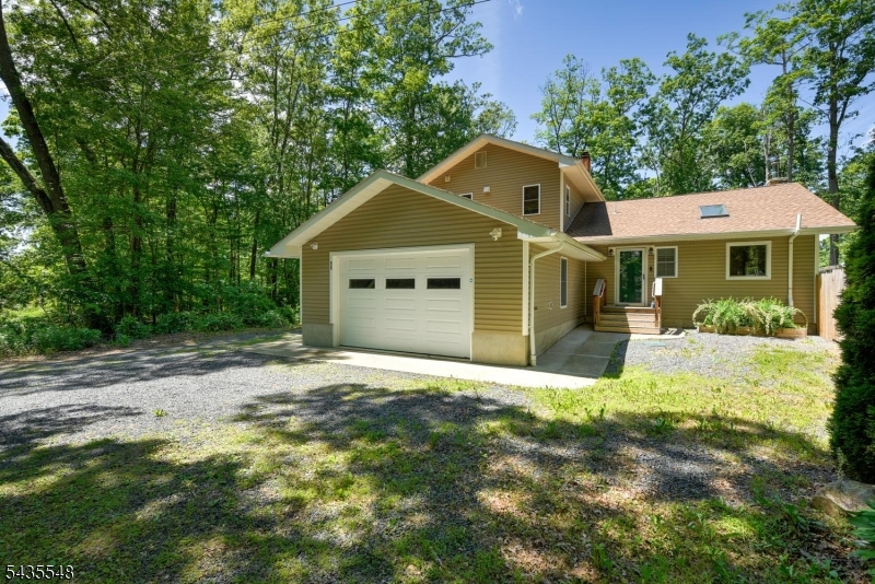 If you've been yearning for the tranquility of a lake home without settling for less comfort and efficiency, then hurry to this gem!!  This home was rebuilt and a large addition was added in 2019, making it a top contender even for the most discriminating buyers.  You'll love the open floor plan including a modern kitchen with a dedicated entertainment hub including a 2nd sink.  Soaring ceilings, large windows and skylights bring the beautiful outdoors inside.  Slip away to the loft to read, write or meditate.  Or escape to one of the two decks and enjoy lake views and wooded landscape complete with a swim/spa hottub!.  The convenient first floor master suite offers 2 double walk in closets and a luxurious bath featuring a huge shower with dual shower heads.  A light and bright home office space along with an additional full bath including laundry offer more conveniences to the first floor.  Upstairs boast 2 more large bedrooms with plenty of closet space and a 3rd full bath.  The walkout basement is 3/4 finished offering many possible uses while also boasting a woodburning stove. What more could you want?  Maybe a 2 car garage and ample parking? Check that off the list as well.  Don't hesitate with this beauty!  And make sure you join Cozy Lake and take advantage of all they have to offer as well.