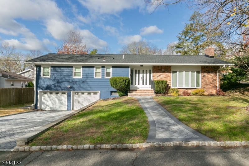 Prepare to fall in love with this stunning, fully renovated ranch offering modern luxury, incredible natural light, and an effortless open-concept flow. From the moment you arrive, the newly paved walkway and crisp blue exterior create an inviting first impression. Inside, you'll find a beautifully redesigned layout featuring soaring ceilings, recessed lighting, and expansive windows that brighten every room. The oversized living room showcases a gorgeous tray ceiling, bay window, and a stone fireplace perfect for everyday living or hosting guests.  The showstopper kitchen offers high-end finishes throughout: quartz-style counters, premium cabinetry, stainless steel appliances, pot filler, custom backsplash, and an abundance of storage. The dining area and sun-drenched bonus space with architectural columns create a seamless setting for entertaining.  All bedrooms are generously sized, with the primary suite offering exceptional space, a walk-in closet, and a beautifully updated en-suite bath with a dual-sink vanity and modern fixtures. Additional highlights include refinished hardwood floors, updated lighting, fresh neutral paint, and a brand-new deck overlooking the private yard.  A rare true two-car garage and expanded driveway complete the picture. Conveniently located near parks, schools, shopping, and major highways, this turn-key home blends sophisticated design with everyday comfort. "Highest and Best" offer packages due Wednesday, November 26th at 2:00pm.