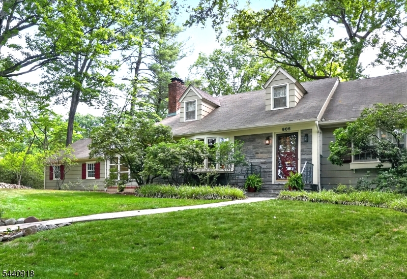 Wonderfully maintained Raised Ranch w/ a beautiful natural stone front, ideally located in the heart of Sleepy Hollow & just a few blocks from the Netherwood Train Station. Built in 1954, this charming home sits on a shaded corner lot & offers 4 spacious bedrooms and 3 full baths. The welcoming foyer leads to a bright living room featuring a marble-front wood-burning fireplace, built-in bookshelf, window seat, & hardwood floors w/ mahogany inlay. The formal dining room boasts decorative moldings & a large picture window overlooking the backyard. The gourmet kitchen, renovated in 2021, features quartz countertops, white shaker cabinets w/ rollout drawers, porcelain tile backsplash, stainless steel sink, recessed & under-cabinet LED lighting, a Frigidaire gas range, GE dishwasher, & stylish exhaust hood. The 1st floor also includes a comfortable family room w/ custom brick-front cabinetry, 2 spacious bedrooms, & an updated full bath. Upstairs are 2 additional bedrooms, including a large primary bedroom w/ a cedar closet, plus a full bath. The partially finished basement offers a full bath, office/gym area, and abundant storage. Major updates include central air (2023), a 3-zone hot water baseboard heating system with a Lennox boiler (2015), 200-amp electric service, whole-house attic fan, and a GE 40-gallon hot water heater. Additional amenities include a 2-car attached garage, blacktop driveway, private slate patio, and beautiful backyard gardens. A 1-year APHW is included.