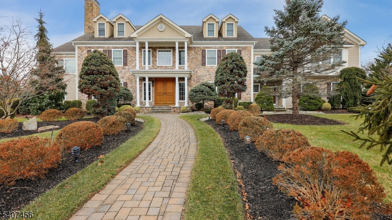 North Edison home nestled on a quiet cul-de-sac in this luxurious custom-built estate blends timeless craftsmanship with elegant design and exceptional functionality.  A striking stone facade creates unforgettable curb appeal, setting the tone for the sophistication found through the home. Step inside to a dramatic 2-story foyer showcasing a stunning starburst walnut inlay.  Rich hardwood floors flow throughout, complemented by crown molding, chair rail, and wainscoting, creating a refined yet welcoming atmosphere in every room.  A distinguished private library offers the perfect work-from-home retreat, complete with custom-built desks, cabinetry, shelving, and its own private exterior exit for added convenience and privacy.  Designed for both entertaining and everyday luxury, the gourmet kitchen is a chef's dream featuring an oversized center island, granite countertops, custom cabinetry, beverage cooler and not one - but 2 walk-in pantries, plus a fully equipped butler's pantry for seamless hosting.  The primary suite is a private sanctuary boasting a spacious sitting room and dual walk-in closets with extensive custom built-in shelving.  For recreation and leisure, the home delivers in style with a dedicated recreational room and a theatre room which is ideal for entertaining guests or relaxing at home.  Every detail of this exceptional residence has been thoughtfully designed to offer luxury, comfort, and functionality - all in a prestigious cul-de-sac setting.