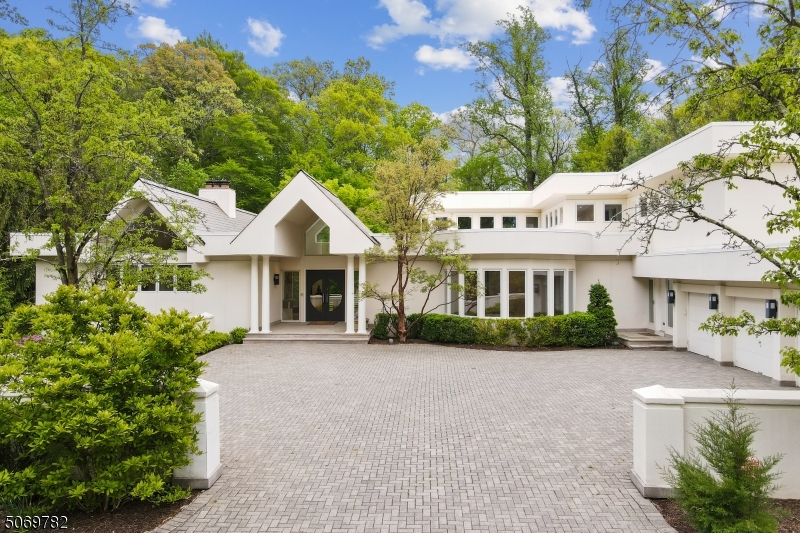 Spectacular custom built south facing estate with incredible natural light from soaring ceilings & floor to ceiling windows providing great views of park-like, private backyard w/ pool & spa, a great open floor plan & unparalleled architectural details, ideally located on 1.3 acres in an ultra-private setting on most prestigious street in Short Hills. Stunning white eat-in kitchen, Great room w/ floor to ceiling windows & fully equipped bar, perfect for entertaining, banquet-sized dining room, home office w/ FP, attached 4-car garage, generous parking court, & walkout lower level w/ natural light, indoor sports court, exercise room, sauna, wine cellar, kitchen & in-law suite w/living room, bedroom & bath. Walk to Hartshorn Elementary & Pingry School! Every amenity including commercial whole house generator!