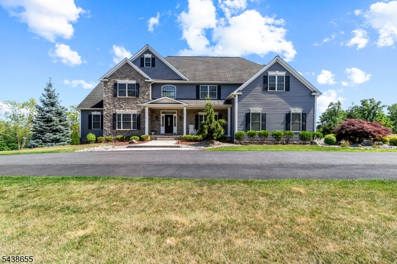 Welcome to luxury living in sought-after Wellington Hills! Built in 2018 and set on nearly 3 picturesque acres with a tranquil creek and breathtaking neighborhood views, this exceptional 4-bedroom, 4.5-bath custom home blends elegant design, modern amenities, and resort-style outdoor living. The thoughtfully designed floor plan features a first-floor office, full bath, spacious laundry room with custom cabinetry, and an open-concept kitchen, dining room, formal living room, and family room with a cozy wood-burning fireplace. Upstairs, the luxurious primary suite offers a private sitting room, custom walk-in closet, and spa-inspired bath. A private guest suite includes its own full bath, while two oversized bedrooms share a Jack-and-Jill bath, with one featuring a versatile bonus room. The finished walk-out basement with powder room provides flexible space for recreation, entertaining, fitness, or a media room. Step outside to your own private retreat featuring a Trex deck with gazebo and outdoor kitchen, multiple patios, an outdoor fireplace, hot tub, and beautifully landscaped grounds. Additional highlights include a 3-car garage, circular driveway, public water, two-zone HVAC, and the opportunity to purchase the home fully furnished for a truly turnkey luxury experience.