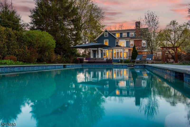 Situated in the curve of magical Sunset Park is this elegant center hall colonial; a perfect marriage of classic details and modern finishes. Fall in love from the moment you make your way up the bluestone walkway and enter the sunblasted foyer. To the left of the foyer is a large, stunning, living room with gorgeous wood burning fireplace. And just beyond, a knock-your-socks off home office with exposed brick and a view to the outdoors. To the right of the foyer is the dining room which easily accommodates a large dinner party. Just past the dining room, the recently renovated kitchen boasting sleek, modern cabinetry, double ovens, cooktop, center island and all the storage you need. Kitchen opens onto the spectacular family room with it's wall of windows to the yard offering a perfect view of the heated pool, outdoor kitchen and brand new outdoor fireplace. Back inside, The dramatic staircase leads to a landing with a lovely meditation room with French doors. Just beyond is the primary suite, with fireplace, walk in closet and primary bath with soaking tub, shower, and double vanity. Down the hall are two more large bedrooms and fully updated hall bath. Third floor has 2 more bedrooms, full bath and flex room perfect for office or guest room. The full, finished basement has 8 foot ceilings, a huge 2nd family room, exercise room, workshop, 1/2 bath, and kitchen area with a walk-out to the outside. 4 car garage could be future ADU or cabana. This is heaven!