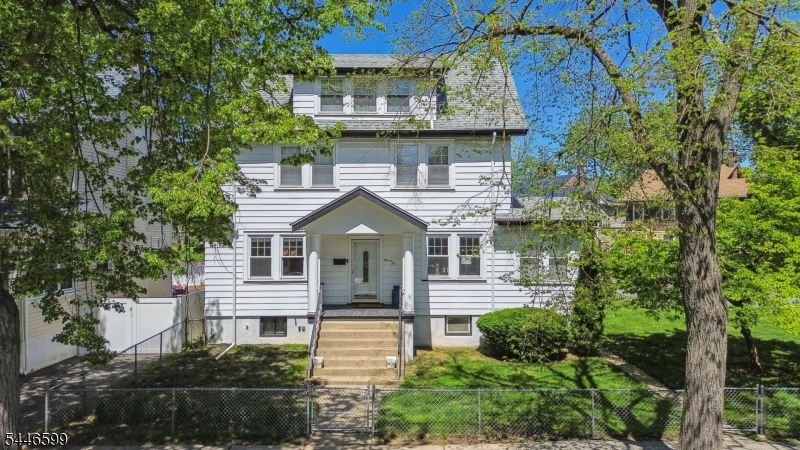 Spacious, sun-filled, and full of character, this 4-bedroom, 2-full-bath rental offers exceptional space and flexibility with convenient access to NYC transportation. Beautiful original oak floors, solid wood doors, and abundant natural light add warmth throughout. The generous layout features a large living room plus an additional sitting area, ideal for a home office, reading room, or lounge. Spacious bedrooms offer ample closet space, while the expansive attic and renovated basement provide incredible bonus space and storage. Laundry is conveniently located in the basement. Outside, enjoy a large fenced backyard surrounded by mature trees and seasonal blooms, with lawn care included. A rare two-car garage and spacious driveway provide abundant off-street parking. Convenient to NJ Transit and NYC transportation. Pets considered. An exceptional rental offering incredible space, beautiful light, parking, and versatility.