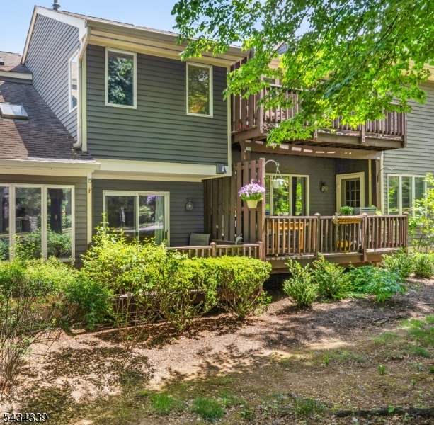 Tucked into the rolling hills of the Beaver Brook Country Club community, this inviting interior townhome offers the kind of easy, comfortable living that makes Hunterdon County so appealing. Mature landscaping, winding neighborhood streets, nearby golf, and close proximity to charming downtown Clinton create a setting that feels both peaceful and connected. Inside, natural light fills the home's open living spaces. The kitchen has been thoughtfully refreshed with new SS appliances, painted cabinetry, updated countertops and sink, and a peninsula that naturally becomes the gathering spot for coffee or casual meals. A breakfast nook provides space for a table for a more comfortable seating option. Just beyond, the dining space flows easily into the living room where skylights and a wood-burning fireplace create a warm and light filled space to enjoy throughout the seasons. Sliders lead to a private deck which overlooks the community setting. Upstairs, the primary suite offers a walk-in closet and ensuite bath with jetted tub and shower, while a second bedroom, full bath, and laundry area complete the level. The finished lower level adds flexible everyday living space with room for movie nights, guests, hobbies, work-from-home needs, plus storage. Recent updates include newer carpeting, fresh paint, washer and dryer, and improvements to the primary bath. Residents also enjoy community tennis courts and easy access to nearby parks, reservoirs, local restaurants and highways!