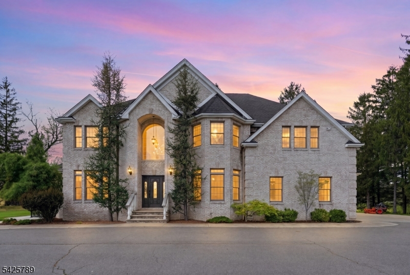 Privately set on 14 farm-assessed acres at the end of a 1,000-foot approach, this custom-built home offers a true estate-like setting. Featuring 5 bedrooms, 4.5 baths, and an oversized 3-car garage, it delivers scale, luxury, and a lifestyle that's hard to replicate. The main level is designed for everyday living and entertaining, with a gourmet kitchen, sunlit breakfast area, spacious living room with detailed ceiling trim, and a private office. Upstairs offers generously sized bedrooms three with en-suites a bonus room, second-floor laundry, and a primary suite with a brand new private sauna. The lower level is substantial, featuring its own kitchen, multiple separate entrances, a full bath, and several finished rooms. The grounds are a standout electrified fenced acreage, a 100x40 greenhouse, private pond, natural spring, fruit trees, and the Pequest River running through the property, plus a gazebo and patio. Built with top-tier systems for efficiency and long-term performance, this is a rare opportunity to own a distinctive North Jersey retreat just minutes from Route 80.