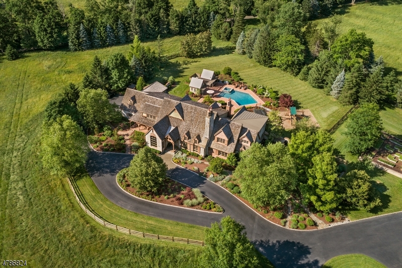 The charming hamlet of Far Hills provides the backdrop to this beautiful 10-acre country estate. Updated in 2006, the 16 room, 6 en-suite bedroom residence embraces todays most luxurious appointments. Artfully crafted millwork, stone, wide plank floors, exposed beams and barn wood details are repeated throughout the home. The open kitchen, breakfast and family rooms reflect the home's prevailing rusticity and inspired architectural design. On the spectacular grounds, with pastures, gardens and bluestone patios, is the pool with spa, pool house with full bath and fireplace. The barn complex includes 5 stalls, full bath, laundry, office and unfinished 2nd level. For the car enthusiast, in addition to the attached 3-car garage, is the barn garage with add'l 6-car capacity. Conv to highways & NJ transit train