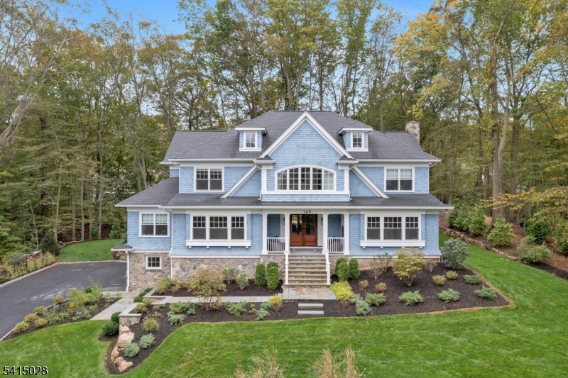 Custom Colonial Revival on the North Side of Summit. Set on .64 beautifully landscaped acres, this custom Colonial Revival was designed by KimTone of TLA Design and built by Cardone Contracting. Blending timeless architecture with modern comfort, the home offers seven bedrooms and seven and a half baths, each with its own en suite bathroom.  The main level features a gracious foyer, formal living and dining rooms, a first floor study, and a chef's kitchen that opens to a spacious family room. French doors lead to a custom bluestone patio and outdoor kitchen with a 42 inch Alfresco grill, custom steel cabinetry, and ample storage, perfect for entertaining. The primary suite is a private retreat with his and her closets, remote controlled drapery, and an oversized walk in shower. The third floor offers a comfortable sitting room, while the lower level includes a mudroom, exercise room, recreation room with wet bar, an additional bedroom, and direct access to the three car attached garage.  This exceptional property combines classic design, modern luxury, and a prime North Side location, just minutes from downtown Summit, top rated schools, and NYC transportation.